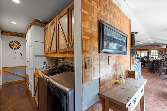 kitchen with washer and dryer and vaulted ceiling