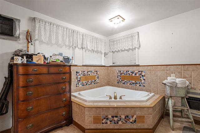 bathroom featuring an AC wall unit, tile patterned flooring, a relaxing tiled tub, tile walls, and heating unit