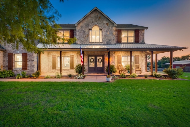 view of front of house with a lawn and a porch