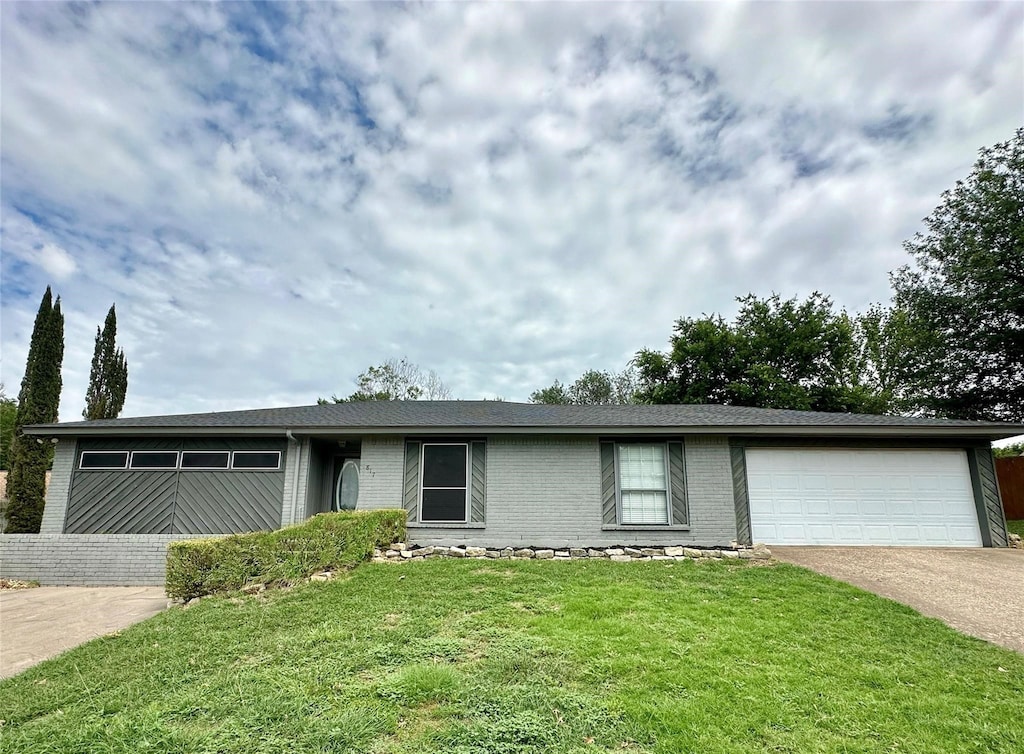 ranch-style home with a garage and a front yard