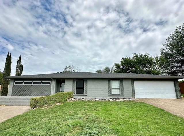 ranch-style home with a garage and a front yard