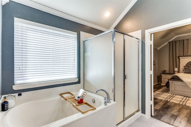 bathroom featuring wood-type flooring, separate shower and tub, vaulted ceiling, and crown molding