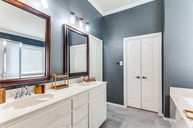 bathroom featuring tile patterned floors, vanity, crown molding, and a tub