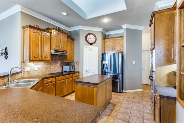 kitchen featuring appliances with stainless steel finishes, ornamental molding, sink, a kitchen island, and light tile patterned flooring