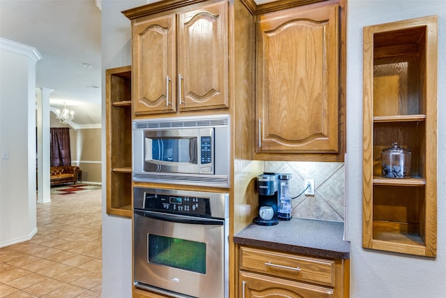 kitchen with backsplash, stainless steel appliances, crown molding, light tile patterned floors, and an inviting chandelier