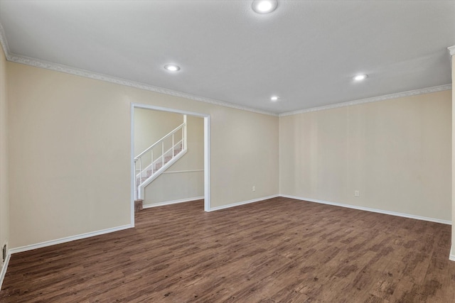 spare room with dark hardwood / wood-style flooring and ornamental molding