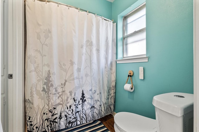 bathroom featuring hardwood / wood-style floors and toilet