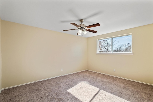 spare room with carpet floors and ceiling fan