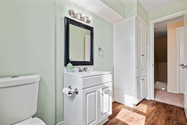 bathroom featuring hardwood / wood-style flooring, vanity, and toilet