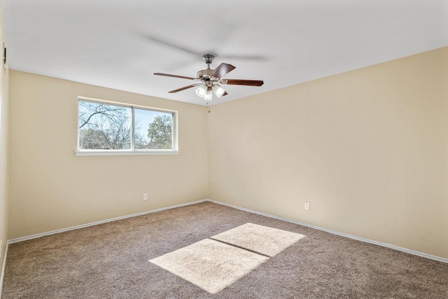 carpeted empty room featuring ceiling fan