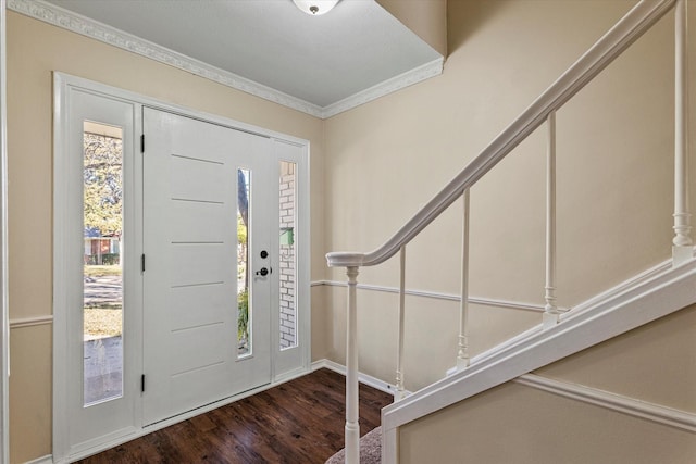 foyer with dark hardwood / wood-style flooring and crown molding