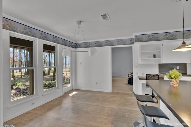 unfurnished dining area featuring light wood-type flooring