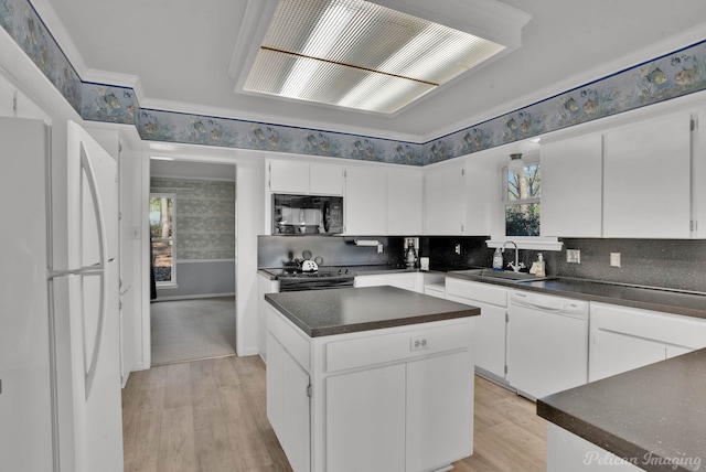 kitchen featuring white appliances, light wood-type flooring, a center island, sink, and white cabinetry