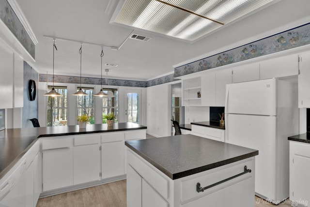 kitchen featuring white cabinets, white appliances, light hardwood / wood-style floors, rail lighting, and pendant lighting