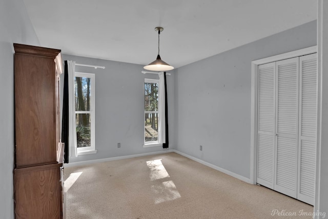 unfurnished dining area featuring light colored carpet