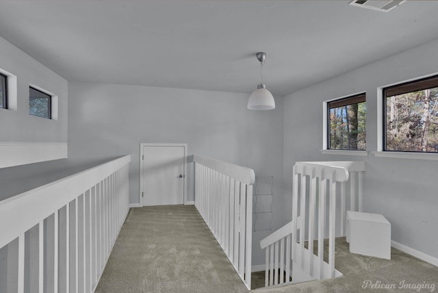 corridor featuring light colored carpet