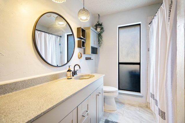 bathroom featuring toilet, a textured ceiling, a shower with curtain, and vanity