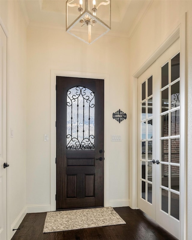 entryway featuring crown molding, french doors, a chandelier, and dark hardwood / wood-style floors