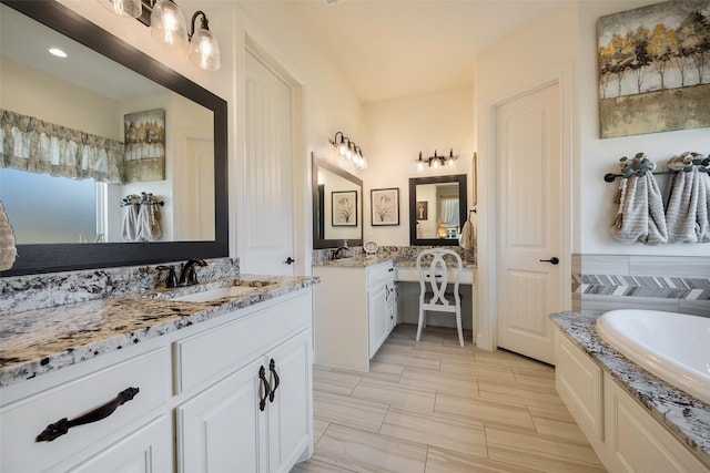 bathroom featuring tile patterned floors, a bathtub, and vanity