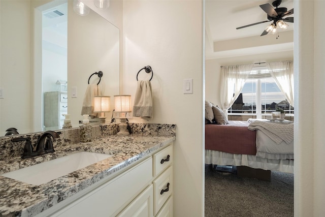 bathroom with ceiling fan and vanity