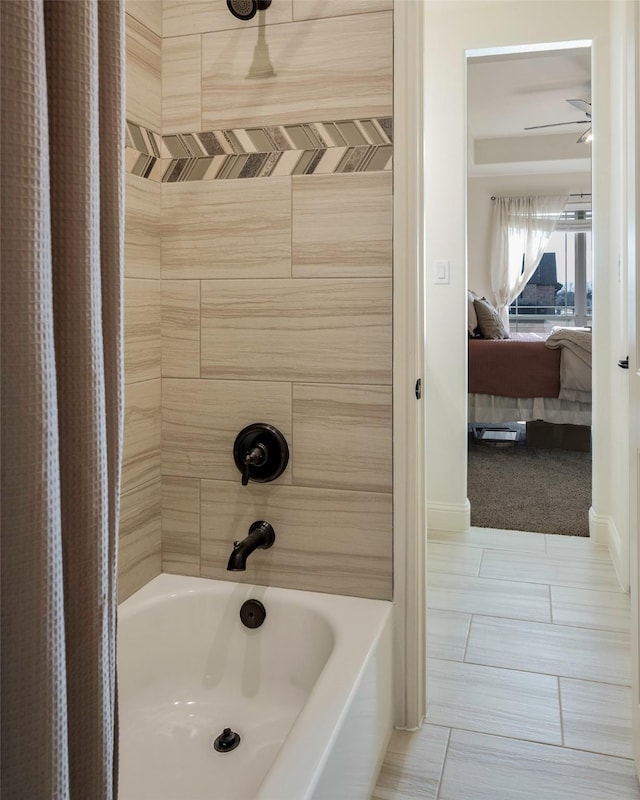 bathroom featuring tile patterned floors and tiled shower / bath