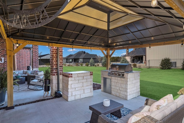 view of patio / terrace featuring a gazebo, a grill, an outdoor hangout area, and an outdoor kitchen