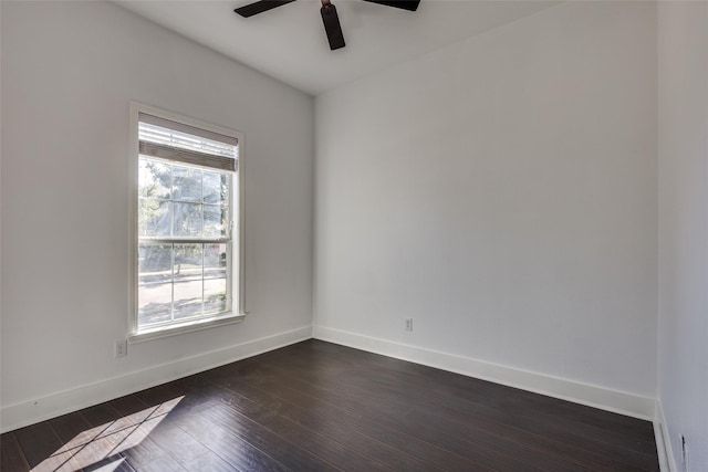 empty room featuring ceiling fan and dark hardwood / wood-style floors