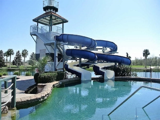 view of pool featuring a water view and a water slide