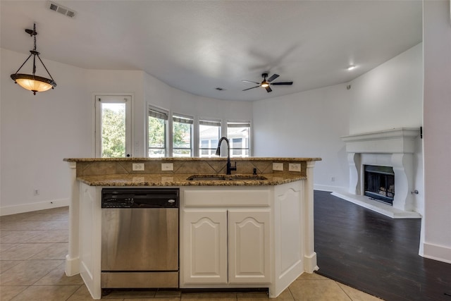 kitchen with white cabinetry, sink, ceiling fan, stainless steel dishwasher, and decorative light fixtures