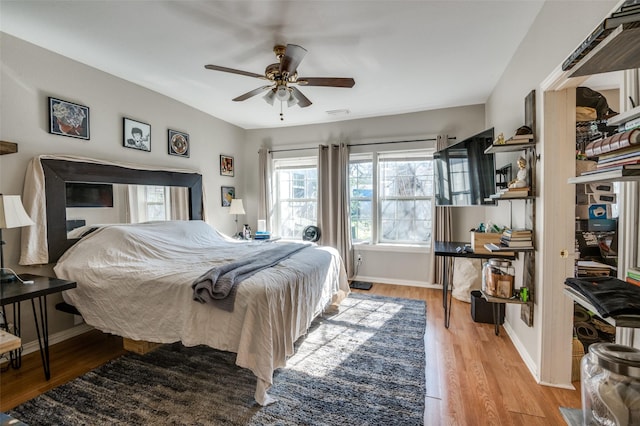 bedroom with ceiling fan and light hardwood / wood-style floors