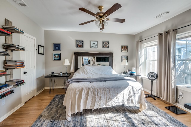 bedroom with ceiling fan and light hardwood / wood-style floors