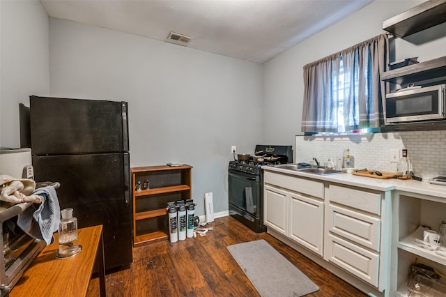 kitchen with sink, white cabinets, black appliances, and dark wood-type flooring