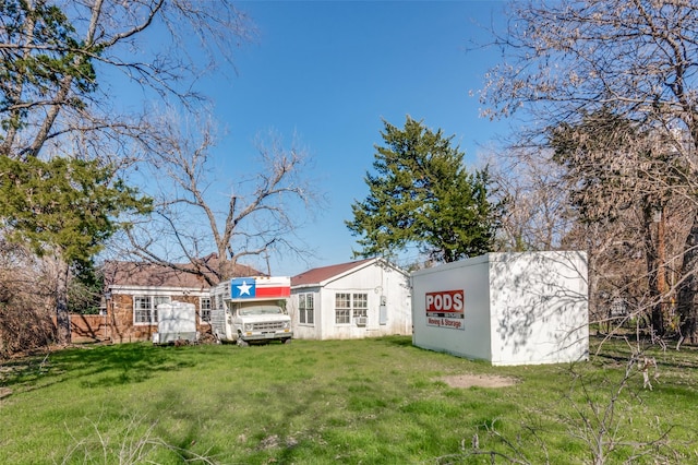 back of property with a lawn