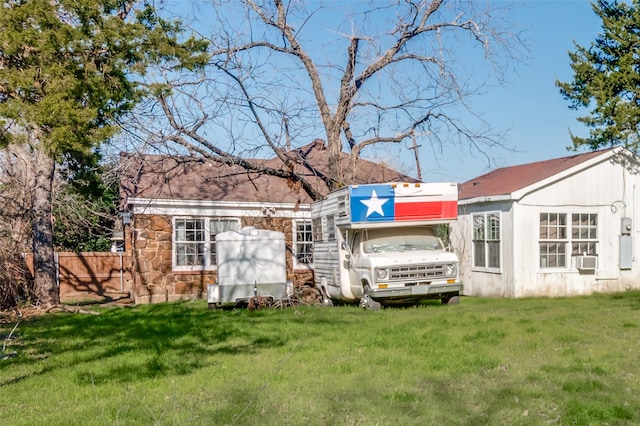 rear view of property with a yard