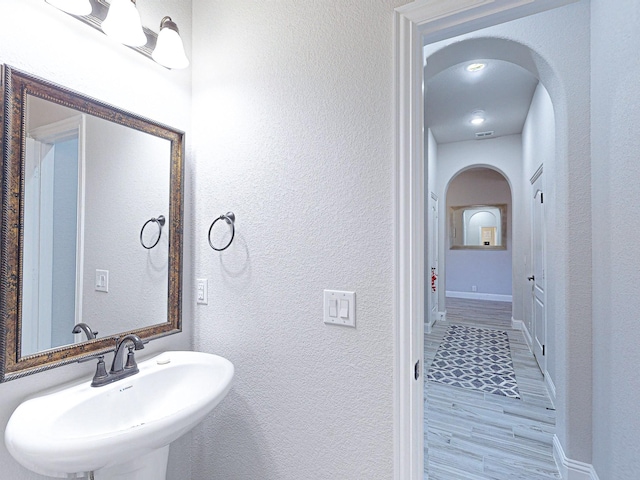 bathroom with sink and hardwood / wood-style flooring