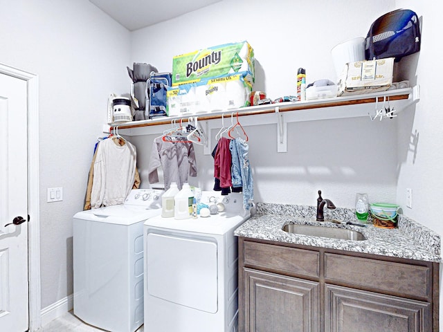 laundry area with sink, cabinets, and separate washer and dryer