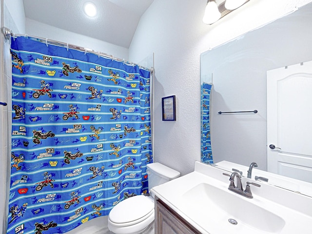 bathroom featuring toilet, vanity, vaulted ceiling, and curtained shower