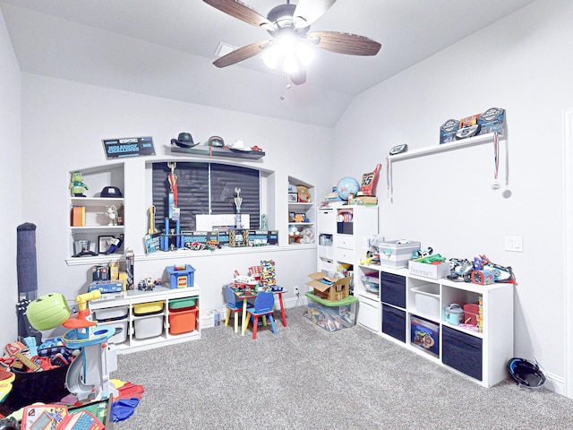 recreation room with ceiling fan, vaulted ceiling, carpet floors, and built in shelves