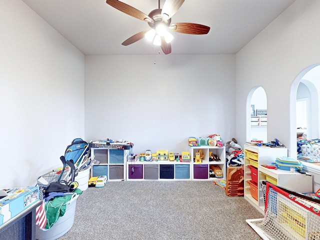 recreation room with ceiling fan and carpet