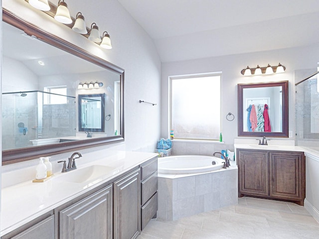 bathroom featuring lofted ceiling, tile patterned flooring, independent shower and bath, and vanity