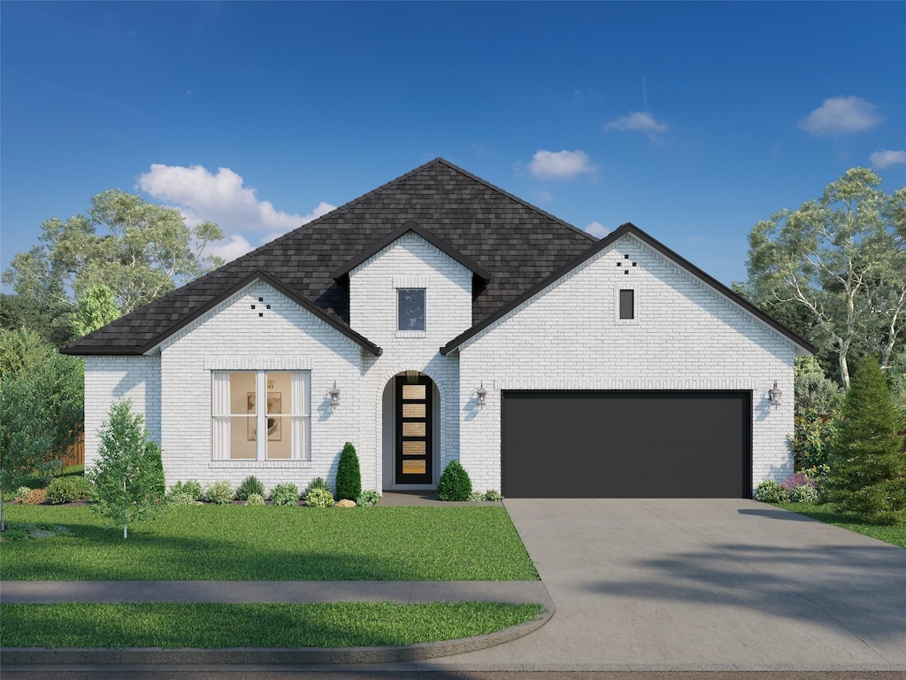 french provincial home featuring a front yard and a garage