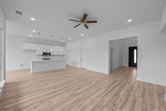 220 Magnolia Dr, Azle, TX 76020 - unfurnished living room with a ceiling fan, recessed lighting, light wood-style flooring, and baseboards