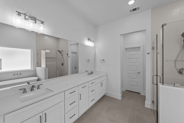 220 Magnolia Dr, Azle, TX 76020 - bathroom with a shower stall, double vanity, a freestanding bath, tile patterned floors, and baseboards