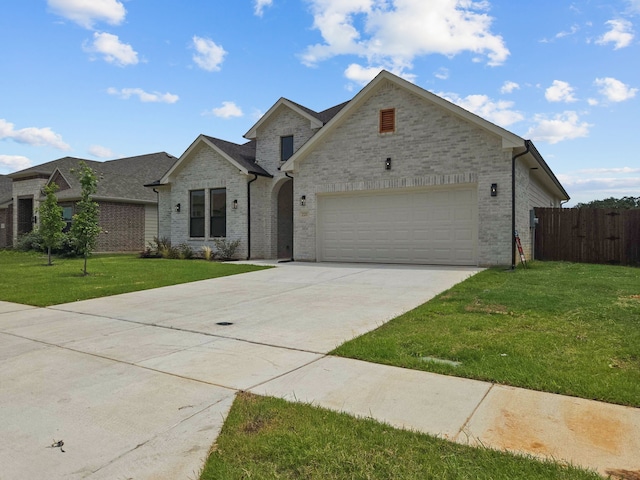 220 Magnolia Dr, Azle, TX 76020 - view of front of house featuring driveway, a garage, and brick siding