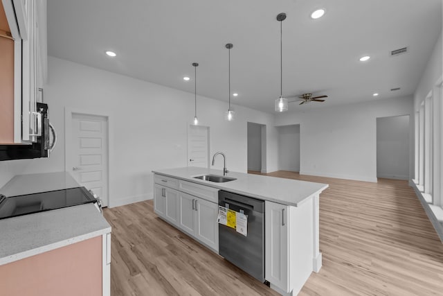 220 Magnolia Dr, Azle, TX 76020 - kitchen featuring stainless steel appliances, a sink, a ceiling fan, white cabinetry, and light wood finished floors