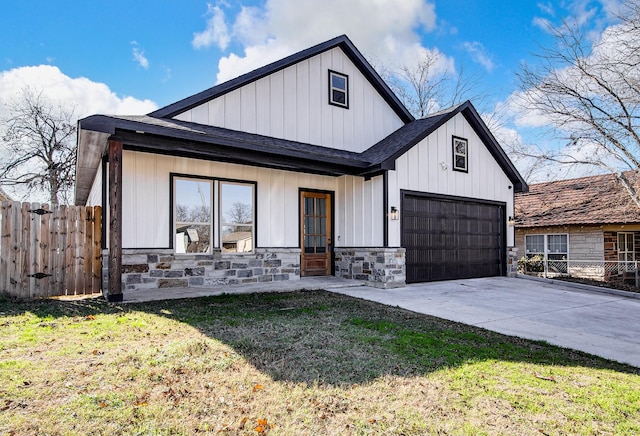 modern farmhouse with a porch, a garage, and a front yard