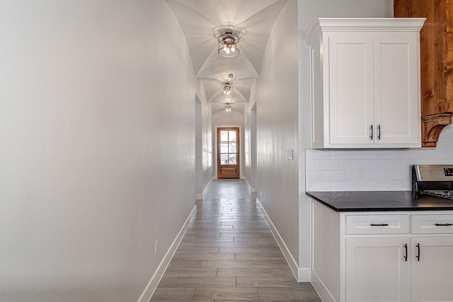 hall featuring lofted ceiling