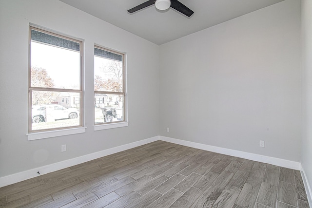 unfurnished room with ceiling fan and light wood-type flooring