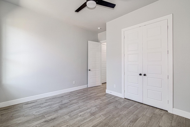 unfurnished bedroom with a closet, light hardwood / wood-style flooring, and ceiling fan