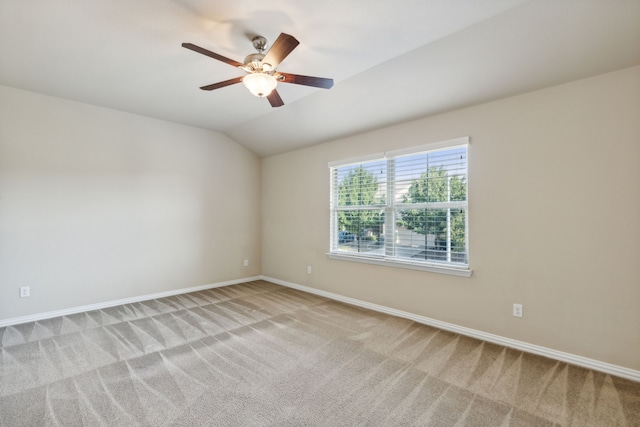 unfurnished room featuring light colored carpet, ceiling fan, and lofted ceiling